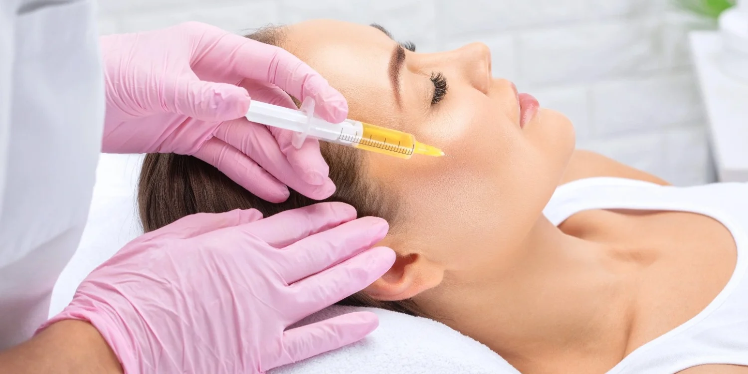 Woman getting Vampire Aesthetics Facial treatment | EC Medical Group